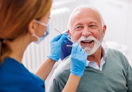 Man smiles in dentist’s chair